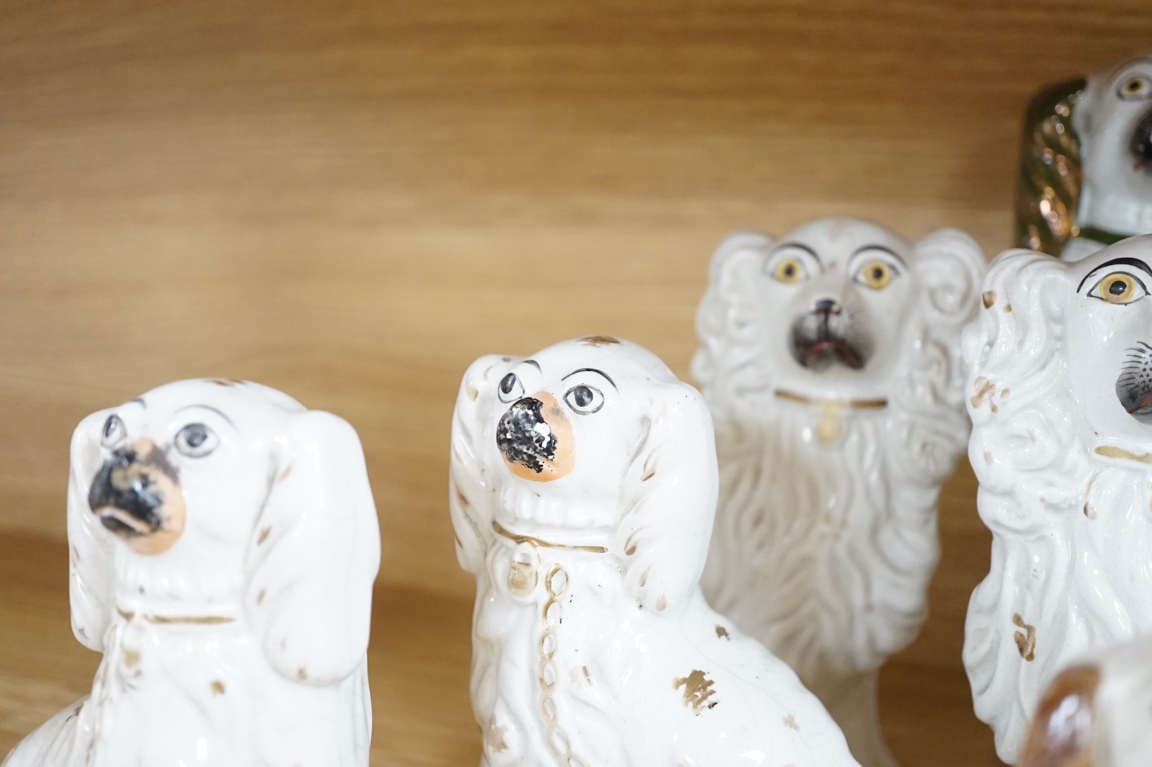 A mixed collection of mostly Staffordshire pottery models of recumbent dogs, hounds, etc. to include Dalmatians- 19.5cms high